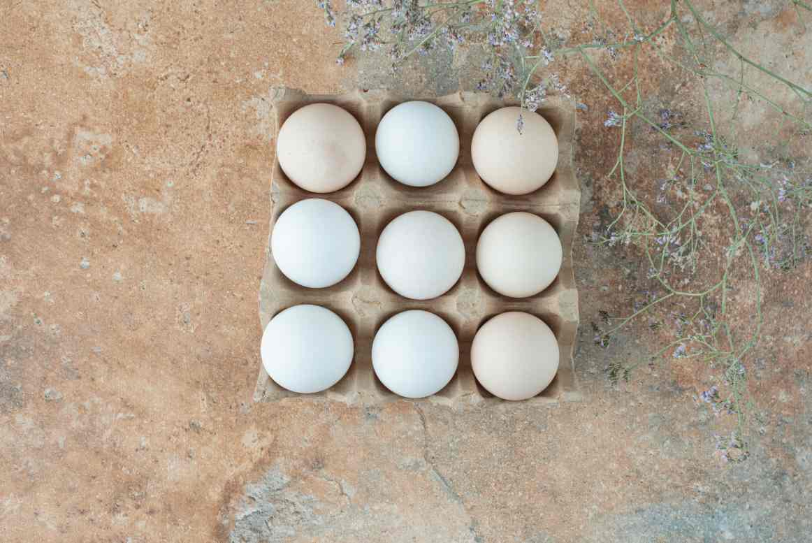 cardboard-box-with-chicken-fresh-white-eggs-marble-table